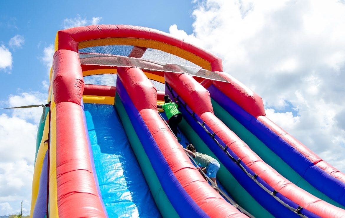 An inflatable slide at a Wishing Well family day